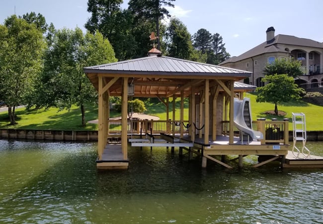 Front of dock with a slide. Boat slip is visible.